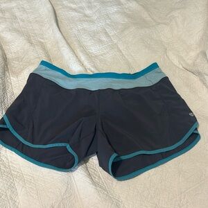 Lululemon running shorts, moisture wicking. Gray with blue band. Size 10